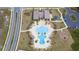 High-angle view of community pool shows design, lounge chairs and a nearby playground at 4211 Little Owl Ln, Kissimmee, FL 34746