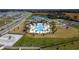 Aerial view of community pool with a unique design surrounded by lounge chairs and landscaping at 4211 Little Owl Ln, Kissimmee, FL 34746