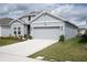 Charming single-Gathering home with a well-manicured lawn, flower beds and attached two-car garage at 4211 Little Owl Ln, Kissimmee, FL 34746