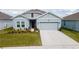 Charming single-Gathering home with a two-car garage, well-maintained lawn, and beautiful landscaping at 4211 Little Owl Ln, Kissimmee, FL 34746