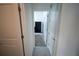 Hallway featuring neutral colored tile flooring leading to the bedroom at 4211 Little Owl Ln, Kissimmee, FL 34746