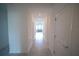 Hallway with tile floors leads to a bright living room at 4211 Little Owl Ln, Kissimmee, FL 34746