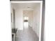 Bright hallway featuring neutral tile flooring, recessed lighting, and white doors at 4211 Little Owl Ln, Kissimmee, FL 34746