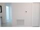 Bright hallway featuring tile flooring, leading to a doorway and closet with paneled doors at 4211 Little Owl Ln, Kissimmee, FL 34746
