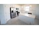 Modern kitchen featuring stainless steel appliances, white countertops and cabinetry, and a central island at 4211 Little Owl Ln, Kissimmee, FL 34746