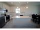 Modern kitchen features stainless steel appliances, white countertops and cabinetry, and a central island at 4211 Little Owl Ln, Kissimmee, FL 34746