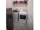 Laundry room featuring white washer and dryer plus shelving at 4211 Little Owl Ln, Kissimmee, FL 34746