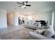 Open-concept living room flows into a modern kitchen with stainless steel appliances and dining area at 4211 Little Owl Ln, Kissimmee, FL 34746