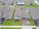 An aerial view of a neighborhood home showcasing the roof, driveway, and manicured landscaping at 4507 Lions Gate Ave, Clermont, FL 34711