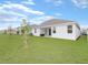 Spacious backyard with green lawn and views of the home's exterior at 4507 Lions Gate Ave, Clermont, FL 34711