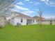 Back of house with spacious green lawn and patio for outdoor enjoyment at 4507 Lions Gate Ave, Clermont, FL 34711