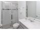 This bathroom features a glass enclosed shower, white vanity, and ample lighting at 4507 Lions Gate Ave, Clermont, FL 34711