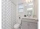 Bright bathroom features a shower with patterned curtain, toilet, and a light vanity at 4507 Lions Gate Ave, Clermont, FL 34711