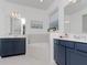 Luxurious bathroom boasts dual vanities, a soaking tub, and stylish fixtures at 4507 Lions Gate Ave, Clermont, FL 34711