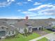 An aerial view of a beautifully landscaped single Gathering home with a three-car garage at 4507 Lions Gate Ave, Clermont, FL 34711