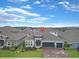 Aerial shot of a home showcasing its well-manicured front yard, landscaping, and inviting entrance at 4507 Lions Gate Ave, Clermont, FL 34711