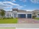 Beautiful one story home featuring a three-car garage, well-manicured lawn, and stone accents at 4507 Lions Gate Ave, Clermont, FL 34711