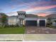 Beautiful one story home featuring a three-car garage, well-manicured lawn, and stone accents at 4507 Lions Gate Ave, Clermont, FL 34711