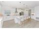 Modern kitchen boasts a large center island with seating, stainless steel appliances, and white cabinetry at 4507 Lions Gate Ave, Clermont, FL 34711