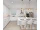 Bright modern kitchen with stainless appliances, bar stool seating, and modern pendant lighting at 4507 Lions Gate Ave, Clermont, FL 34711