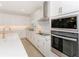 Detailed shot of kitchen featuring stainless oven and microwave built into the cabinetry at 4507 Lions Gate Ave, Clermont, FL 34711
