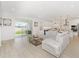 Bright, open-concept living room features modern decor, sliding glass doors, and seamless flow to the kitchen at 4507 Lions Gate Ave, Clermont, FL 34711