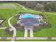 An aerial view of the community pool showcasing its layout, lounge chairs, and lush landscaping at 4507 Lions Gate Ave, Clermont, FL 34711