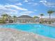A bright swimming pool and surrounding patio with ample lounge seating and shade for relaxing at 4507 Lions Gate Ave, Clermont, FL 34711