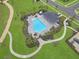An aerial view of the community pool featuring lounge seating, tropical foliage, and walkable pathways at 4507 Lions Gate Ave, Clermont, FL 34711