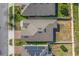 Drone shot directly above a house roof showing the lawn, fence, and nearby solar panels at 485 Disa Dr, Davenport, FL 33837
