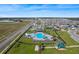 Aerial view of community pool, playground, and residential neighborhood at 485 Disa Dr, Davenport, FL 33837