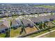 An aerial view of the neighborhood showcasing the home's backyard, landscaping, and surrounding properties at 485 Disa Dr, Davenport, FL 33837