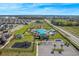 Community pool area and playground in the neighborhood with plentiful parking and a well manicured lawn at 485 Disa Dr, Davenport, FL 33837