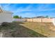 View of the spacious backyard featuring a white privacy fence and a partial view of adjacent houses at 485 Disa Dr, Davenport, FL 33837