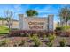 Orchid Grove community sign surrounded by manicured landscaping on a sunny day at 485 Disa Dr, Davenport, FL 33837