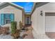 Inviting front entrance with a charming blue door, brick pathway, and manicured landscaping at 485 Disa Dr, Davenport, FL 33837