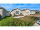 A cozy single-Gathering home with a tidy front lawn, blue window shutters, and an attached garage at 485 Disa Dr, Davenport, FL 33837