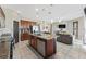Open-concept kitchen featuring an island, stainless steel appliances and seamless living room access at 485 Disa Dr, Davenport, FL 33837