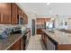Well-equipped kitchen featuring stainless steel appliances, granite countertops, and ample cabinet space at 485 Disa Dr, Davenport, FL 33837