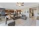 Open-concept living area with a large sectional sofa, a view of the kitchen, and tile flooring at 485 Disa Dr, Davenport, FL 33837
