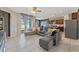 Spacious living room with a large sofa, open to the kitchen and dining area with tile floors at 485 Disa Dr, Davenport, FL 33837
