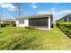 The screened-in lanai overlooks a backyard with green grass and mature landscaping, providing a private outdoor space at 4918 Drawdy Ct, St Cloud, FL 34772
