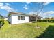 Expansive backyard with vibrant green grass, mature trees, and a screened-in patio, perfect for outdoor entertaining at 4918 Drawdy Ct, St Cloud, FL 34772