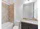 Well-lit bathroom featuring a shower over tub combination and granite countertop vanity at 4918 Drawdy Ct, St Cloud, FL 34772