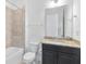 Bathroom featuring a vanity with granite countertop, a tub with shower, and a toilet at 4918 Drawdy Ct, St Cloud, FL 34772