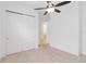 Neutral tone bedroom featuring carpet, ceiling fan and a walk-in closet at 4918 Drawdy Ct, St Cloud, FL 34772