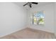 Bedroom with neutral walls and carpet flooring, and a large window that brings in lots of natural light at 4918 Drawdy Ct, St Cloud, FL 34772