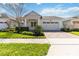 Charming single-story home boasting a manicured lawn, paver driveway, and an attached two-car garage at 4918 Drawdy Ct, St Cloud, FL 34772