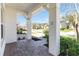 Covered front porch with brick pavers offering a glimpse of the landscaped community at 4918 Drawdy Ct, St Cloud, FL 34772