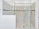 Glass enclosed shower tiled with built in soap racks and a showerhead at 4918 Drawdy Ct, St Cloud, FL 34772